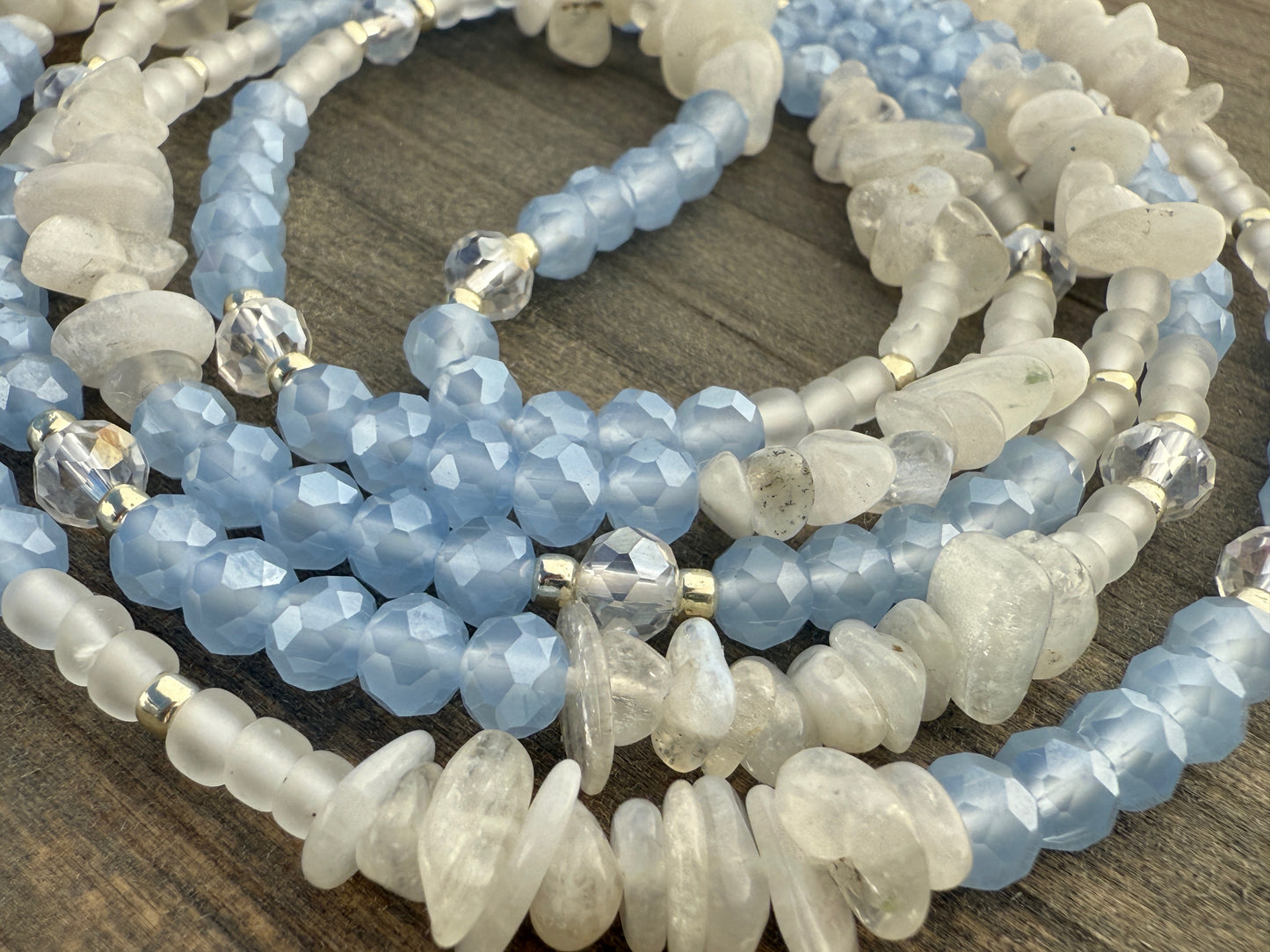 Blue and white waist beads with faceted crystals, frosted glass, and natural moonstone, handmade by Sia Body Beads.