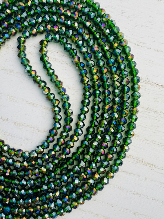 Green beaded necklace on a light wooden surface