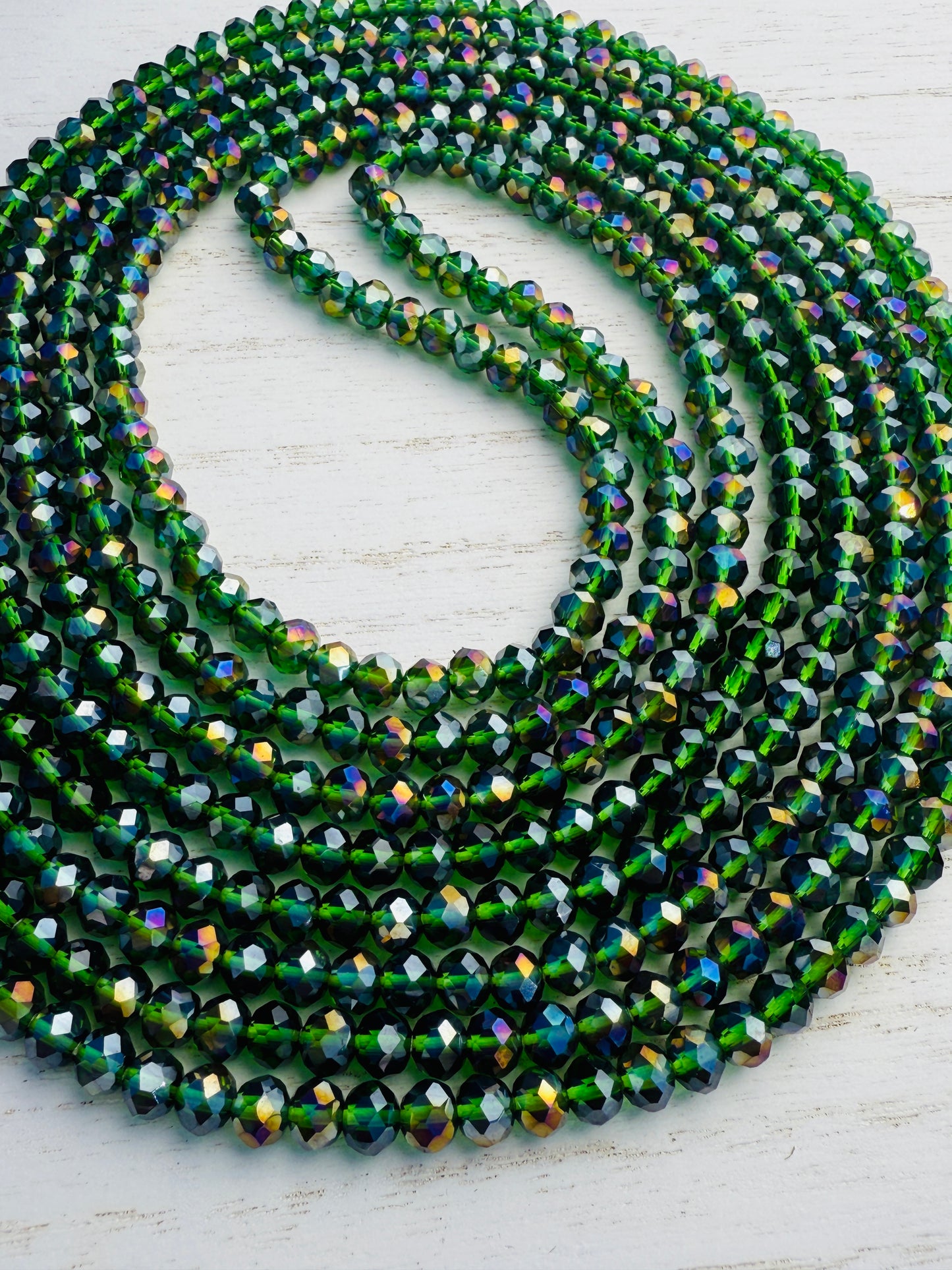 Green beaded necklace on a light wooden surface