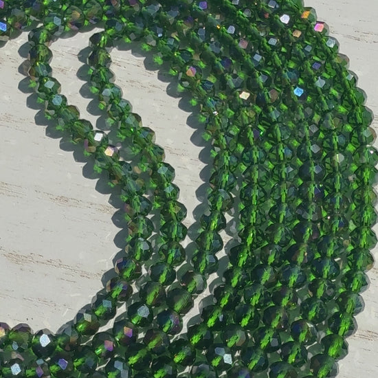 Green beaded necklace on a light wooden surface