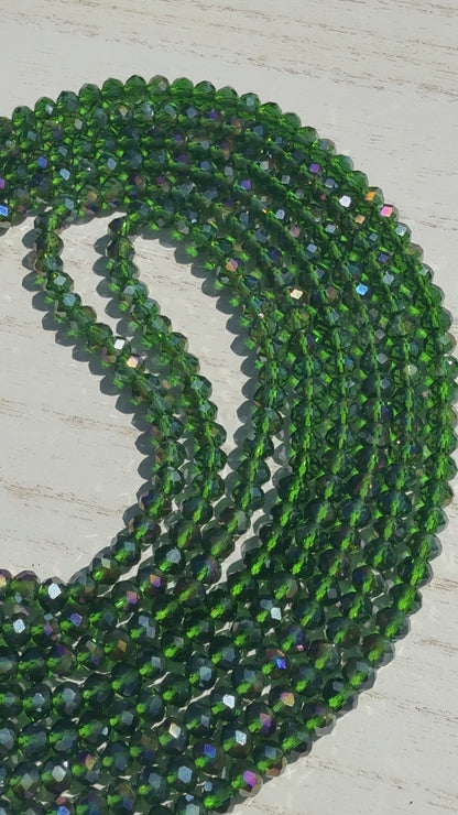 Green beaded necklace on a light wooden surface