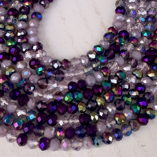 iridescent purple and lavender crystal waist beads arranged in a circular display on a light background